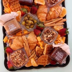 peanut and almond butter, strawberry jam and marmalade in a breakfast tray